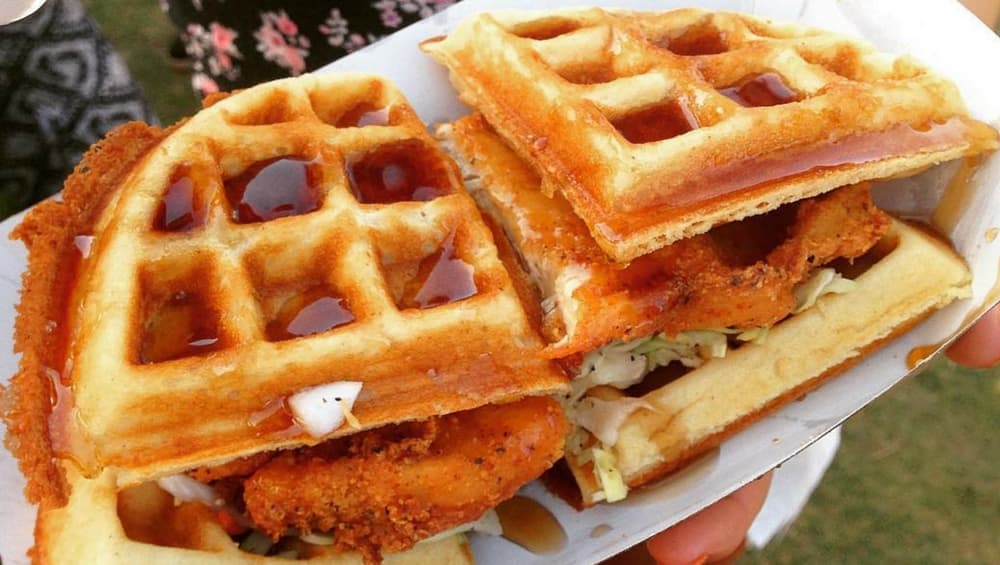 Crisp chicken fritters encased between waffle buns and drizzled with maple syrup for a yummy contrast of flavours. Crisp chicken fritters encased between waffle buns and drizzled with maple syrup for a yummy contrast of flavours.