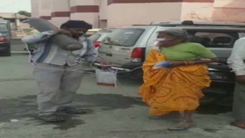 Man Awaits Ambulance Carrying Mother's Oxygen Cylinder on Shoulder at Agra in Uttar Pradesh