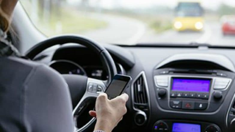 Talking on mobile while driving not offence: Kerala HC Talking on mobile while driving not offence: Kerala HC