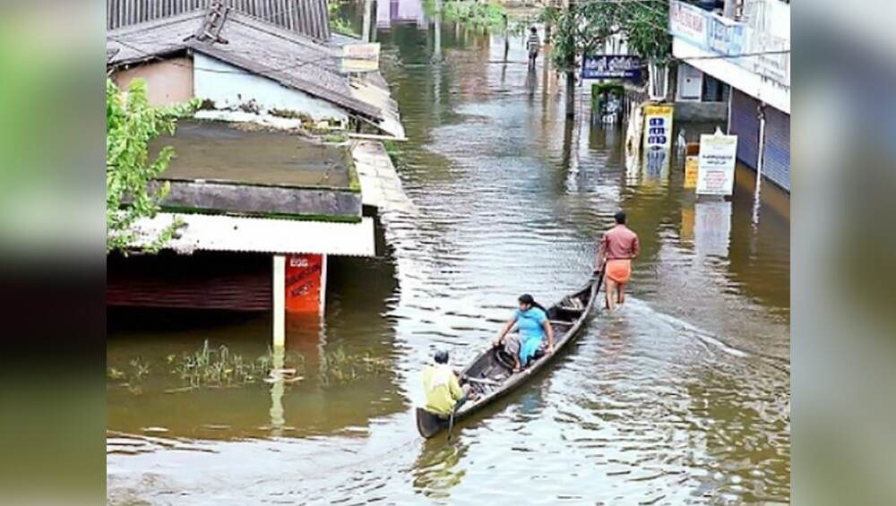 As streets have flooded, locals use boats on roads in Kerala. As streets have flooded, locals use boats on roads in Kerala.