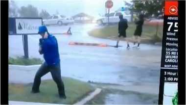 Weatherman Exaggerates Hurricane Florence Wind Force in North Carolina While Two Men Stroll by in a Viral Video