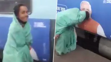 This Video of Woman KISSING Narendra Modi’s Picture on Train Is Going Viral and the Reactions Are Even Better!