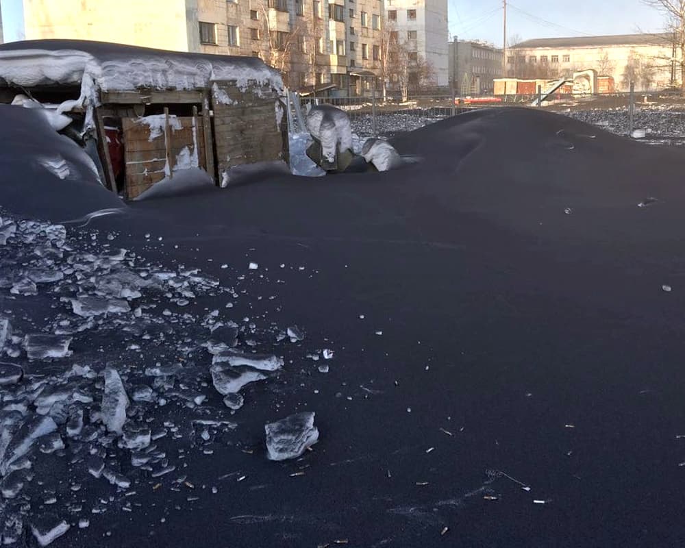 Heaps of snow are all dark black due to pollution. Heaps of snow are all dark black due to pollution.