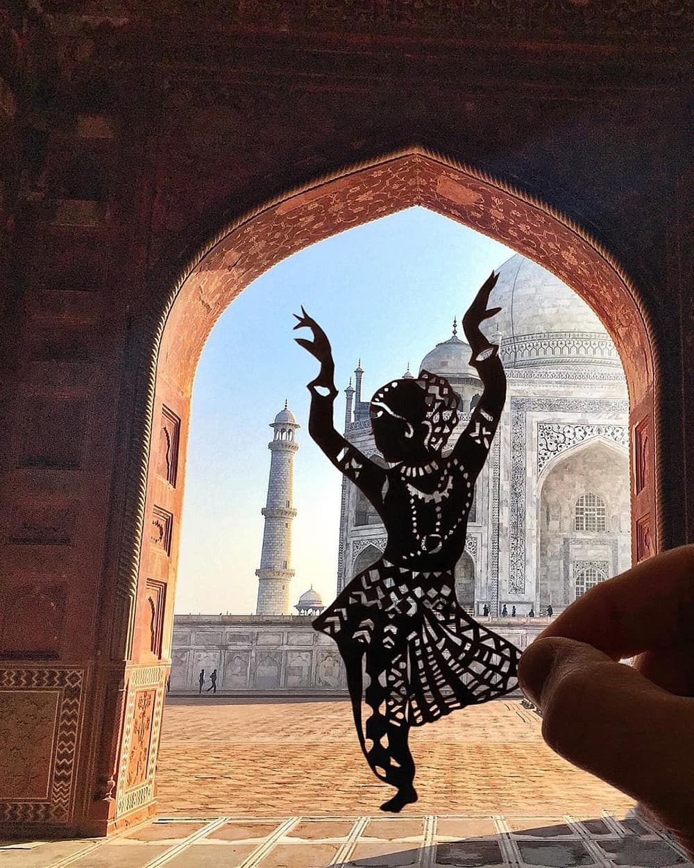 Taj Mahal makes for a perfect background setting for this art. Taj Mahal makes for a perfect background setting for this art.