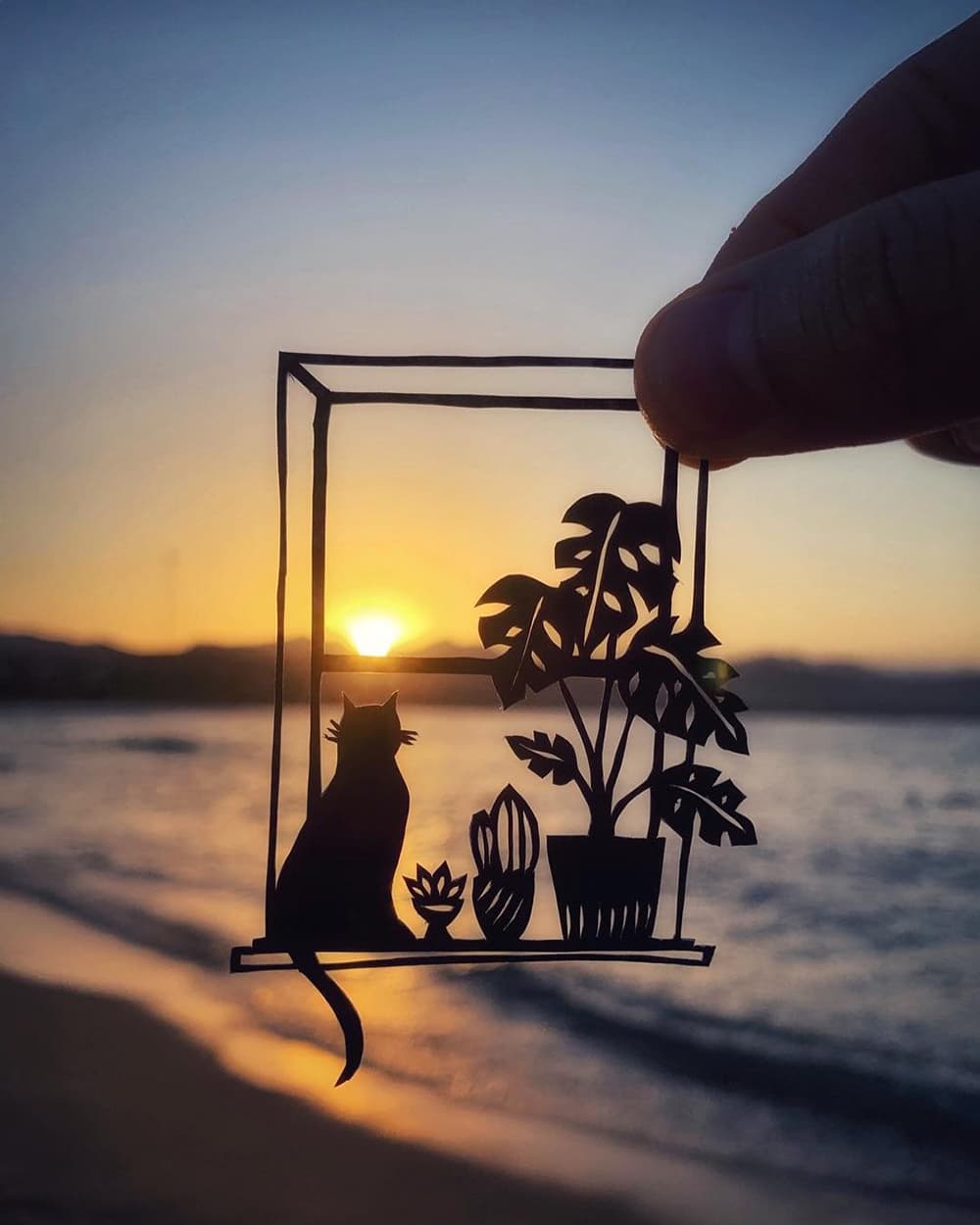 A cat on a window frame carved out on a leaf by artist Kanat Nurtazin. A cat on a window frame carved out on a leaf by artist Kanat Nurtazin.