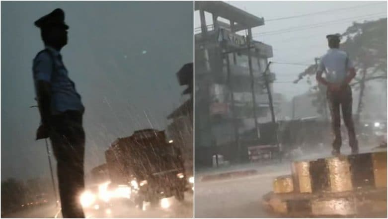 Video of Assam Traffic Police Mithus Das Braving Heavy Rain and Storm During Duty Goes Viral Video of Assam Traffic Police Mithus Das Braving Heavy Rain and Storm During Duty Goes Viral