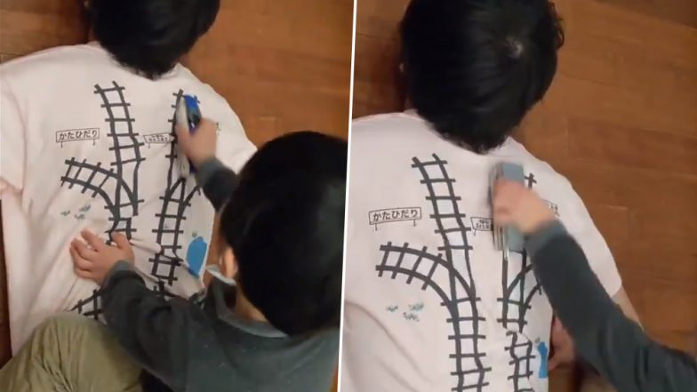 Genius Dad! Japanese Man Designs T-shirt With Railway Tracks on Back So That He Gets a Massage Whenever His Child Plays (Watch Viral Video)