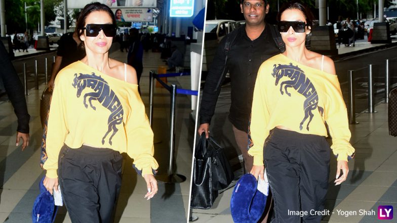 Yo Or Hell No! Malaika Arora In Yellow Wrangler T-Shirt at Mumbai Airport