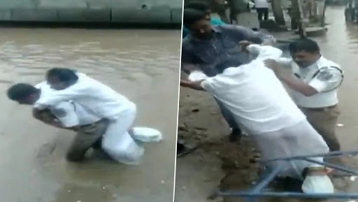 Hyderabad Traffic Cop Wades Through Waterlogged Road Carrying Man on HIs Back