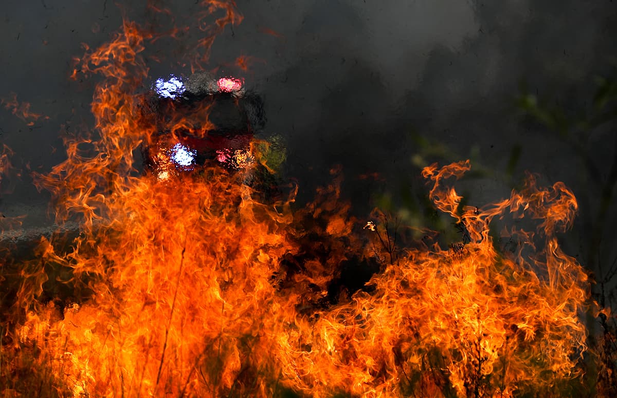 Firefighters battle the flames during bushfires near Taree, New South Wales, Australia. Firefighters battle the flames during bushfires near Taree, New South Wales, Australia.