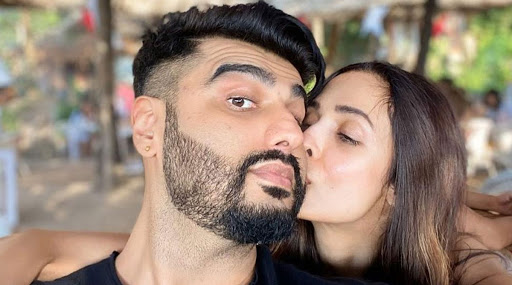Malaika Arora wishes everyone a Happy 2020 by planting a kiss on her beau Arjun Kapoor's cheek