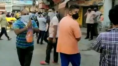 Delhi: Man Showers Petals on People Outside Liquor Shop in Chander Nagar for Helping the Economy, Government (Watch Video)