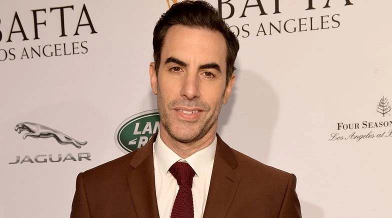 Actor Sacha Baron Cohen Gets A Rally To Sing Racist Lyrics (Watch Video)