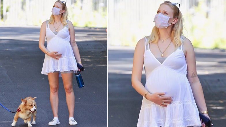 Mom-To-Be Sophie Turner Cradles Her Baby Bump As She Steps Out For A Walk With Joe Jonas and Her Parents (View Pics Inside)