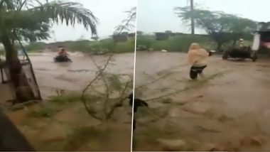 Maharashtra: Motorbike Rider in Dhule Gets Caught in Flash Flood, Rescued by Locals (Watch Video)