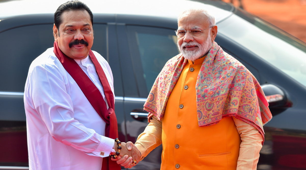 Sri Lanka president holds up umbrella for Modi during rains. See photo