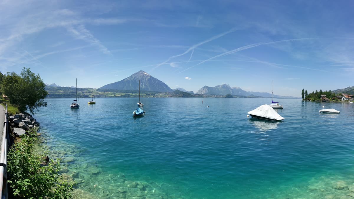 Embedded within an imposing backdrop of mountains, the deeply-blue Lake Thun lies on the northern periphery of the Alps, between the Bernese Oberland towns of Thun and Interlaken. Embedded within an imposing backdrop of mountains, the deeply-blue Lake Thun lies on the northern periphery of the Alps, between the Bernese Oberland towns of Thun and Interlaken.