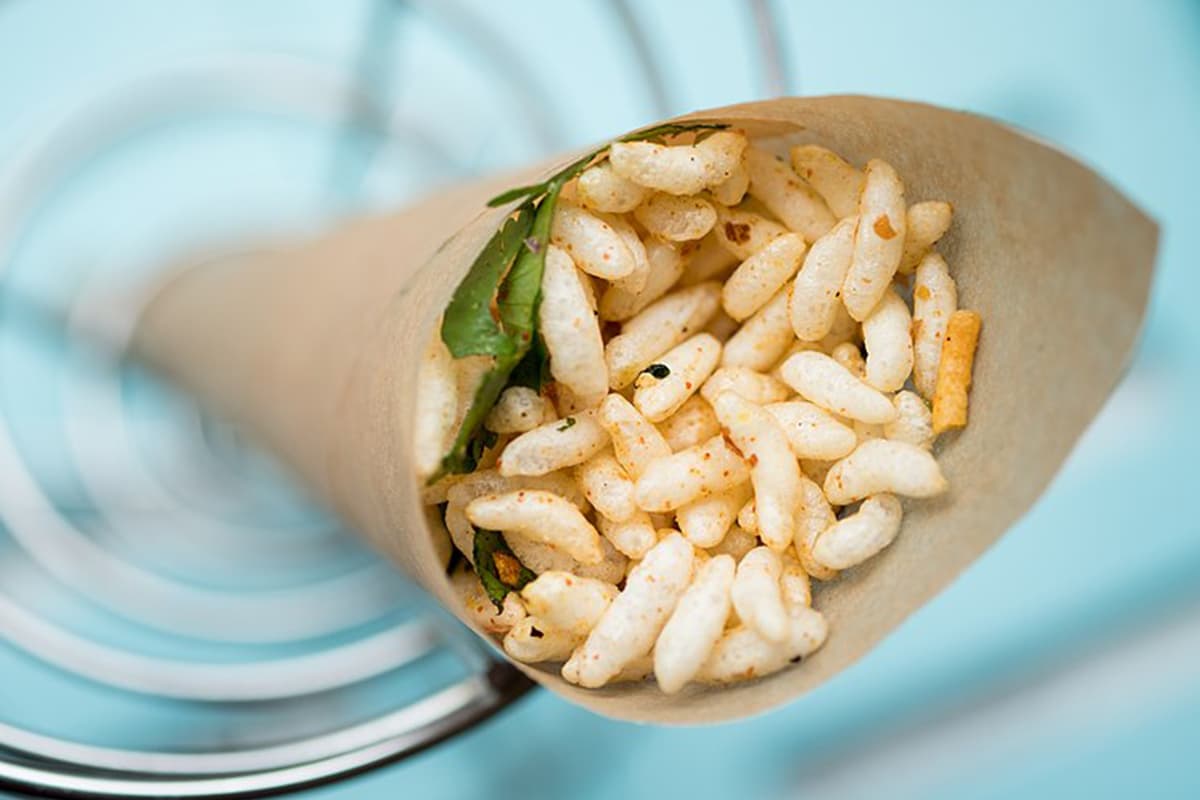 Jhalmuri is a popular Bengali street snack, made of puffed rice and an assortment of spices, vegetables, chanachur and mustard oil. Jhalmuri is a popular Bengali street snack, made of puffed rice and an assortment of spices, vegetables, chanachur and mustard oil.