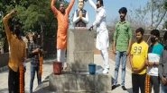 India News | Shri Hindu Takht Pays Tribute to Rajiv Gandhi by Bathing His Statue with Milk in Ludhiana