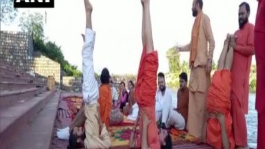 India News | Saints in Haridwar Practice Yoga on Banks of Ganga Ahead of International Day of Yoga