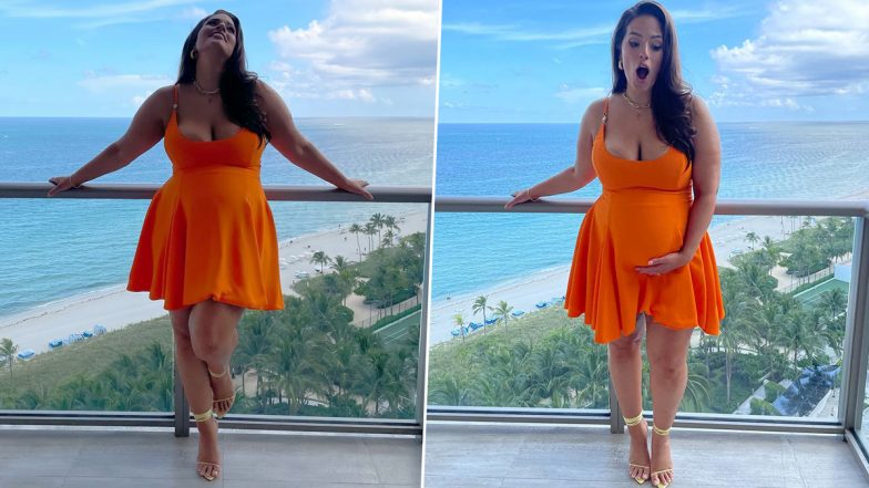 Ashley Graham Showcases Trendy Maternity Style In Flirty Orange Midi Dress, Says ‘Baby Bumpin’ (View Pics)