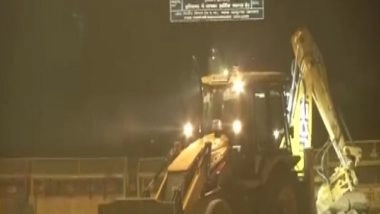 India News | Farmers Protest: Delhi Police Starts Removing Barricades Using Earth Mover at Tikri, Ghazipur Borders