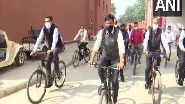 India News | Mansukh Mandaviya Rides Bicycle to Delhi's Pragati Maidan, Highlights Cycling Benefits