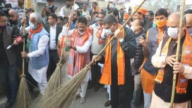 India News | Ahead of PM Modi's Visit, Dharmendra Pradhan Undertakes Cleanliness Campaign in Varanasi