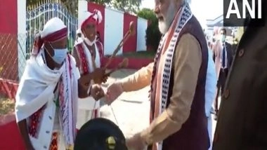 India News | Manipur: PM Modi Tries His Hand at Playing Traditional Musical Instruments During Visit to Imphal