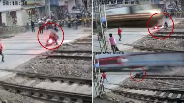 Biker Narrowly Escapes a Close-Call As Speeding Train Shatters His Bike (Watch Video)