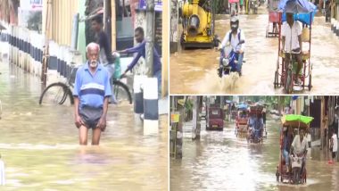 Assam Rains: People Walk Through Waterlogged Streets As Heavy Rains Lashes Assam (See Pics)