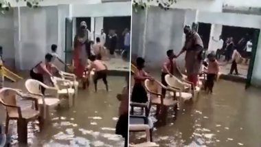 Students Get Drenched in Rain Water to Make Chair Bridge For Teacher to Help Her Cross Flooded School Compound in Mathura; Watch Viral Video