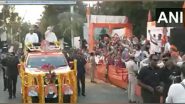 India News | Gujarat: People Shower Flower Petals on PM Modi, CM Bhupendra Patel During Roadshow in Rajkot