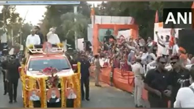 India News | Gujarat: People Shower Flower Petals on PM Modi, CM Bhupendra Patel During Roadshow in Rajkot