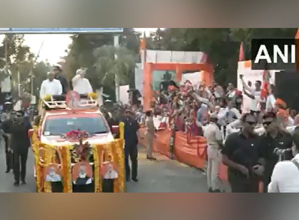 India News | Gujarat: People Shower Flower Petals on PM Modi, CM Bhupendra Patel During Roadshow in Rajkot