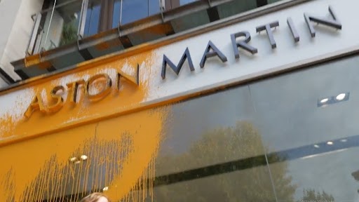Video: Climate activists branded ‘thugs and vandals’ by UK Home Secretary Suella Braverman throw bright orange spray paint at London’s Aston Martin showroom