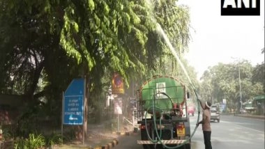 India News | Delhi: Sprinkling of Water Done on Roads, to Check Rise in AQI