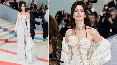 Met Gala 2023: Anne Hathaway Arrives in Versace White Tweed Dress with Thigh High Slit and Cutouts Held by Gold Safety Pins (View Pics and Video)