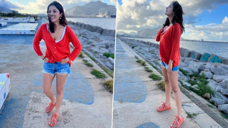 Shehnaaz Gill Makes a Fashion Statement in Italy, Sporting Trendy Red Cardigan and Blue Shorts at the Seafront (View Pics)