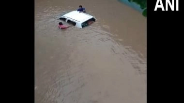 India News | Gujarat: Car Submerged at Flooded Navsari Underpass, Occupants Rescued