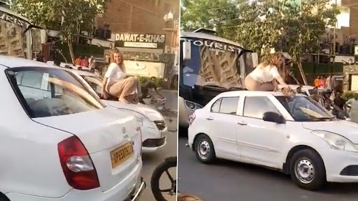 Woman Creates Ruckus in Public in UP Video: Foreigner Sits on Car Roof on Busy Road in Varanasi, Misbehaves With Bystanders