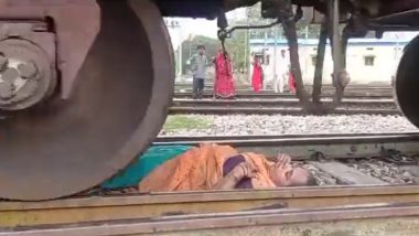 Goods Train Passes Over Woman in Uttar Pradesh Video: Woman Escapes Unhurt After She Falls Unconscious on Railway Track in Kasganj As Train Runs Over Her