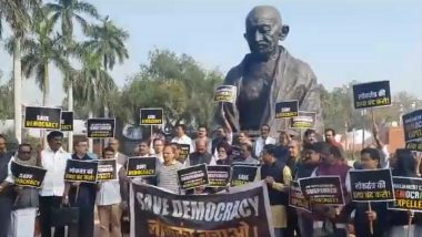 'Save Democracy': Opposition MPs Protest With Banner and Placards Over Suspension of 141 MPs for Winter Session of Parliament (Watch Video)