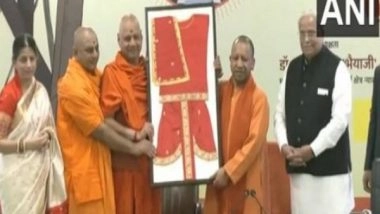 India News | UP CM Yogi Adityanath Participates in Programme of Offering Clothes Made for Lord Ram