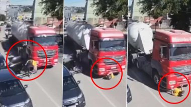 Biker Narrowly Escapes Death After He Falls Under Truck as Another Driver Carelessly Opens Door of His Car Parked on Roadside, Chilling Video Surfaces
