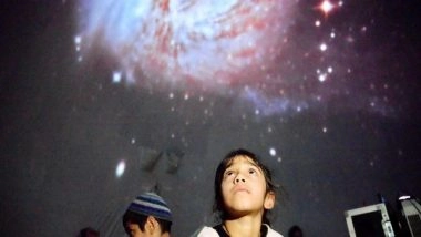 World News | Israeli Astronomers Discover Enigmatic Red Supermassive Black Hole Veiled in Cosmic Dust