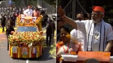 PM Narendra Modi Showered With Flower Petals During His Roadshow in Kerala’s Palakkad (Watch Video)