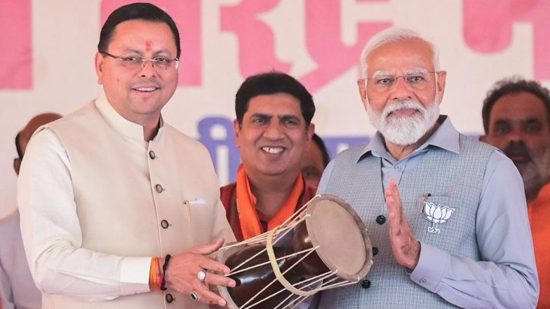PM Narendra Modi Receives 'Hudka' As Gift From Uttarakhand CM Pushkar Singh Dhami at Rishikesh Rally, PM Tries His Hands on Musical Instrument (See Pics and Video)