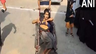 India News | Lok Sabha Elections: Specially-abled Voter Arrives in Wheelchair to Cast Vote in UP's Kasganj