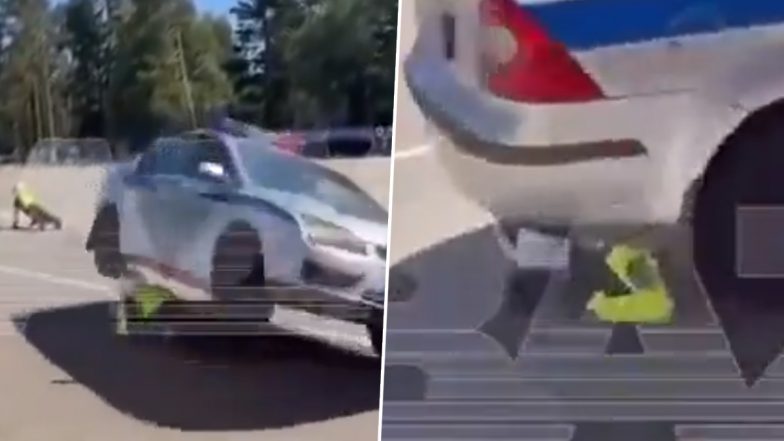 Police Car Stunt in Russia Goes Horribly Wrong: Ford Focus Balancing on Two Wheels Crashes on Officer During Demonstration, Drags Him (Disturbing Video)